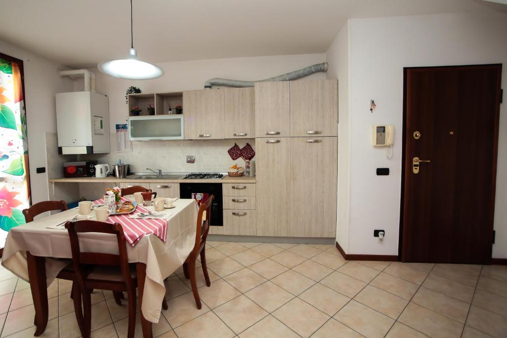 a kitchen with a table with a table cloth on it at Guest House Onde Chiare in Reggio Emilia