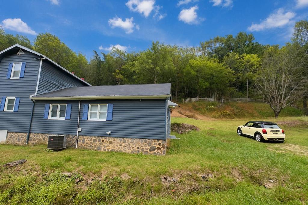 a house with a car parked in front of it at Wildlife with style in the mountains in Stanley