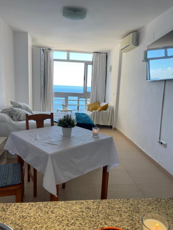 a living room with a table and a view of the ocean at &luxe vista mar& in Calpe