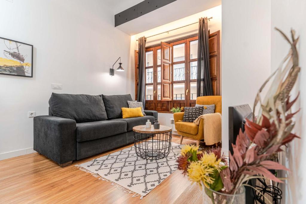 a living room with a couch and a table at Apartamento Abenhamar in Granada