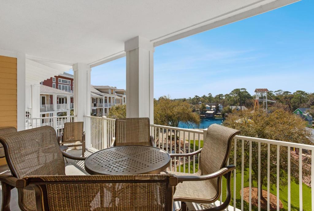 a patio with a table and chairs on a balcony at Observation Point North 456 in Destin
