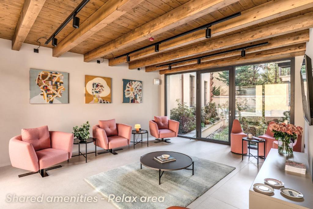 a living room with orange chairs and a table at Agnesi Statue in Milan
