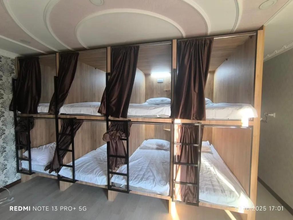a room with three bunk beds in a room at Екохостел in Bishkek