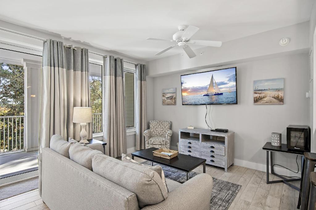 a living room with a couch and a tv at Pilot House 413 in Destin