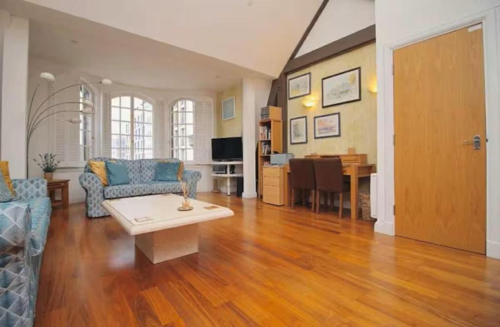 a living room with a couch and a table at The Cardiff Central Pad – Stylish 2-Bed Apartment in Cardiff