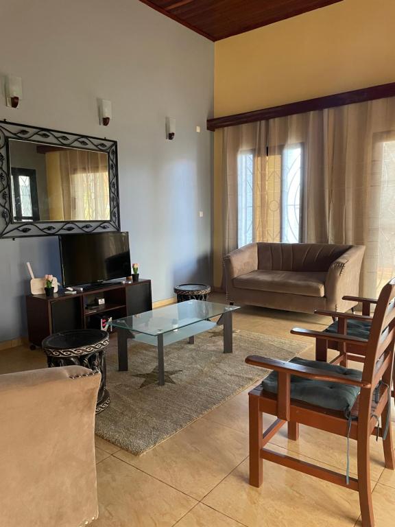 a living room with a couch and a table at LesOiseaux in Yaoundé