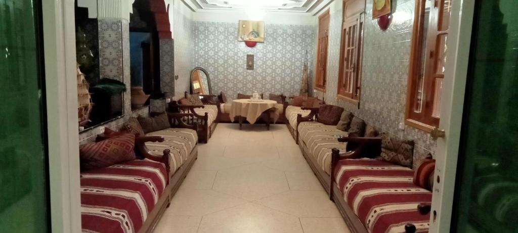 a restaurant with couches and a table in a room at Auberge Lion de l'Atlas in Azrou