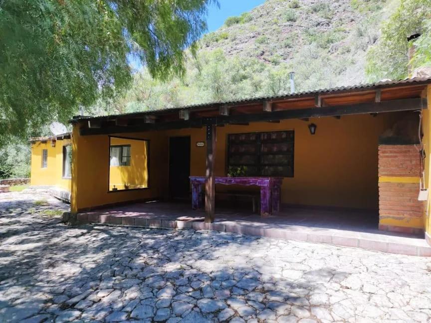 a small yellow building with a grass roof at Corazonada in Volcán