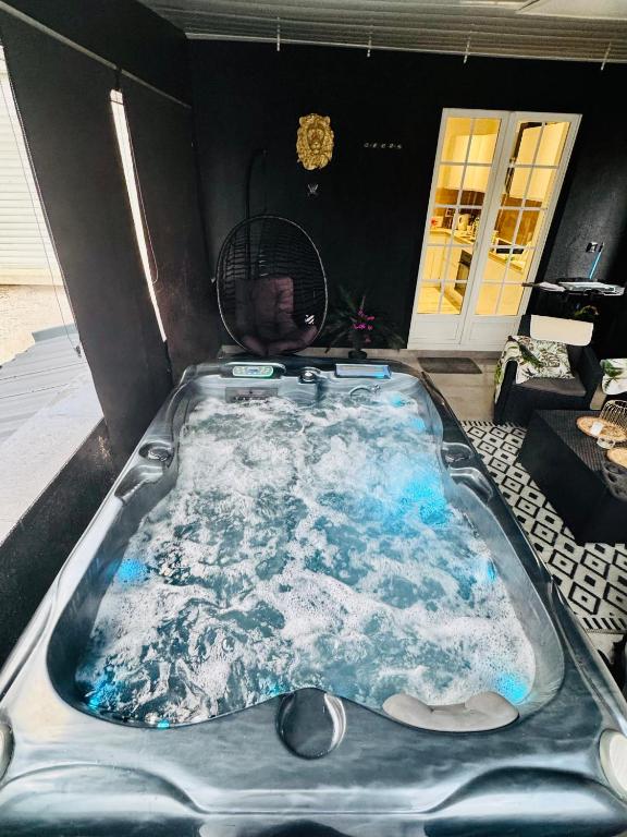 a jacuzzi tub in the middle of a room at Dynasty luxury Spa Appartement 100M2 Jacuzzi Terrasse in Holtzheim