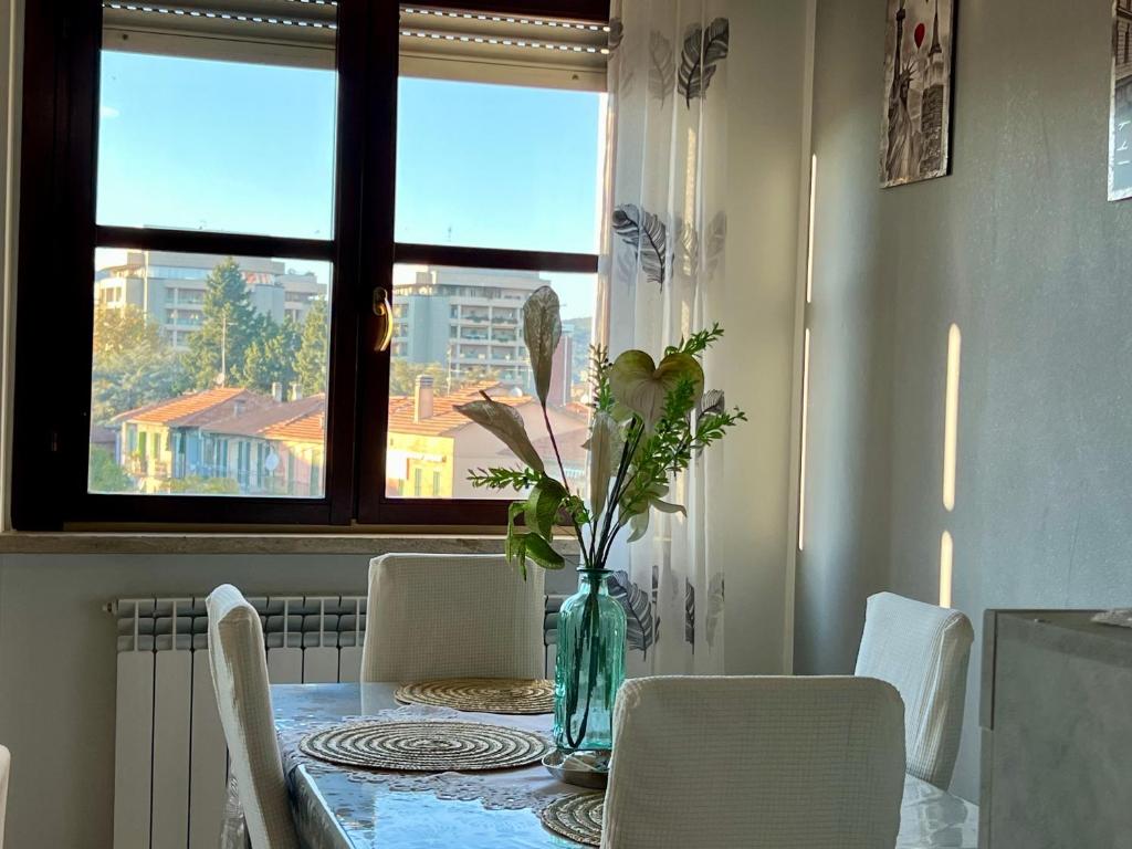 a dining room table with a vase of flowers on it at Casa BELLOCCHIO in Perugia