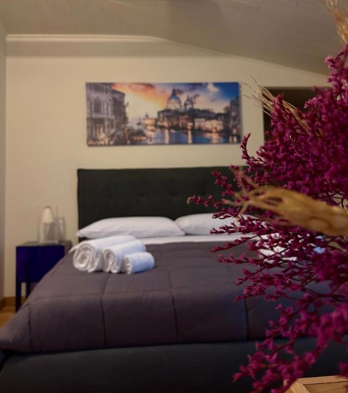 a bedroom with a bed with towels on it at Sangida Home in Lamezia Terme