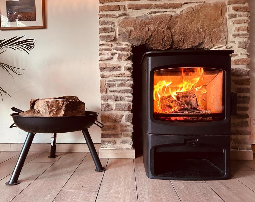 a stove with a fire in a room at COCOONING near DINANT 300m from River Meuse in Blaimont