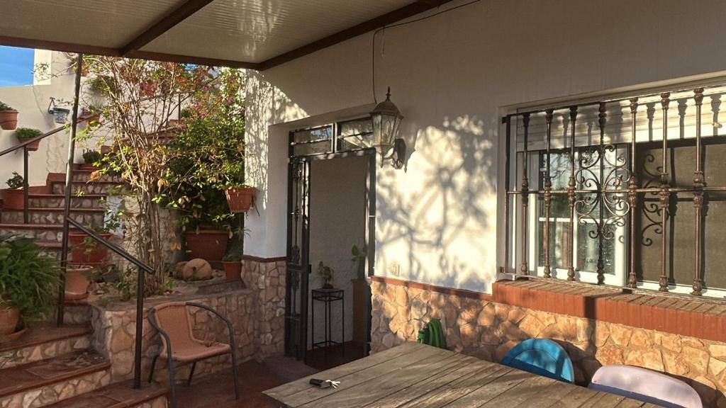 a patio with a wooden table and a window at Las cuevas de María in Bácor