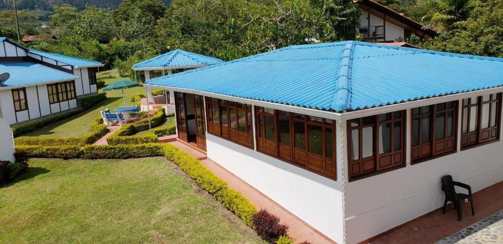 an overhead view of a house with a blue roof at Villa Del Viento in Calima