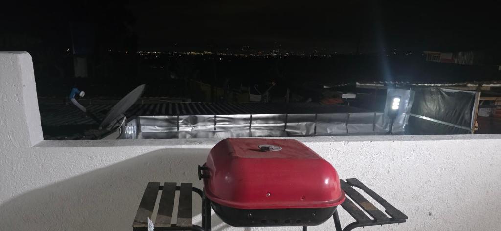 a red suitcase sitting on a bench on a balcony at Aparto hotel del centro in Filandia