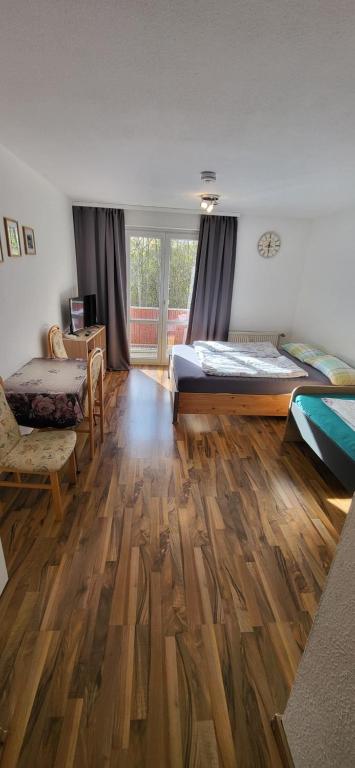 a bedroom with two beds and a wooden floor at Apartment Homburg Uni-Nähe in Homburg