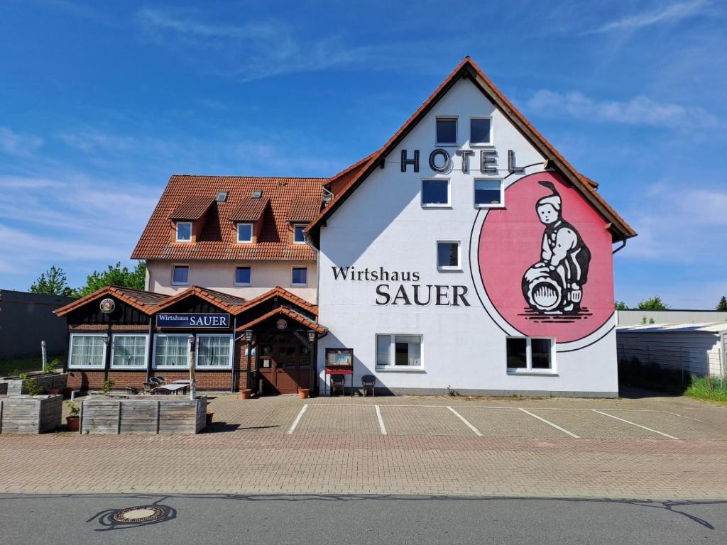 a hotel with a sign on the side of it at Pension Bockenem Extra in Bockenem