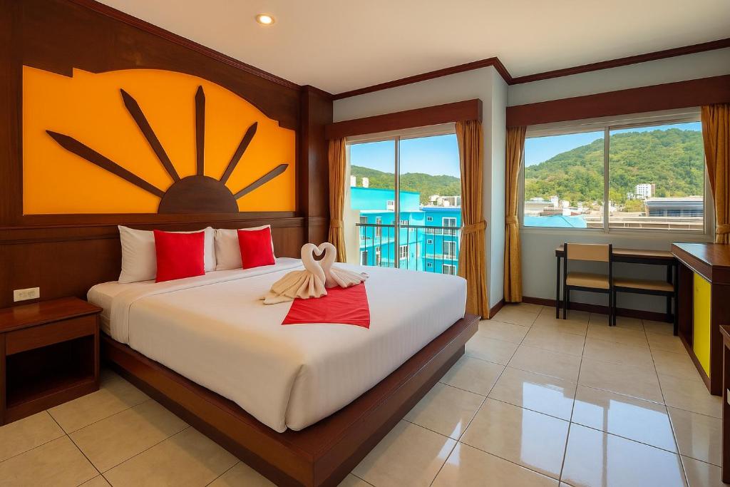 a bedroom with a bed with a large clock on the wall at Nova Patong in Patong Beach