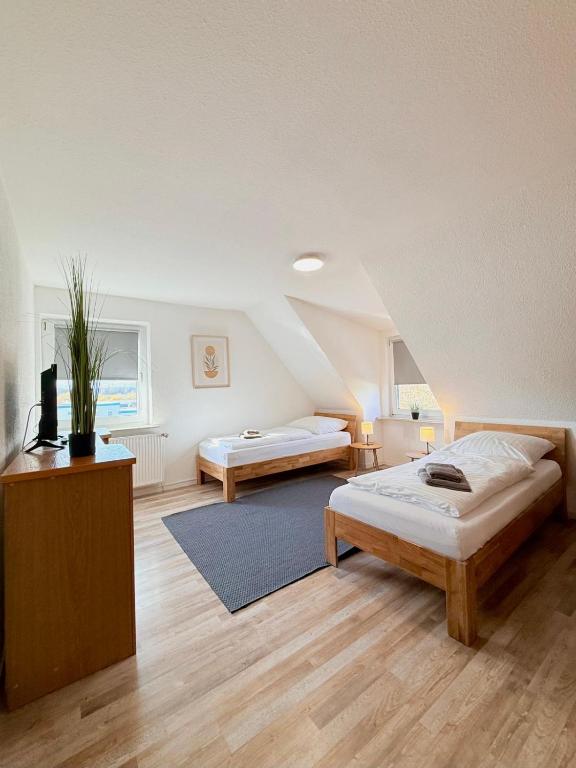 a bedroom with two beds in a attic at Hotel & Pension Bockenem in Bockenem
