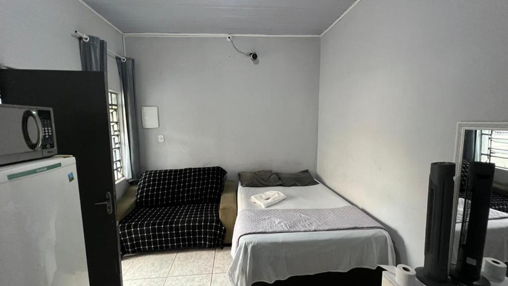 Ένα ή περισσότερα κρεβάτια σε δωμάτιο στο Hospede-se No Coração de SP