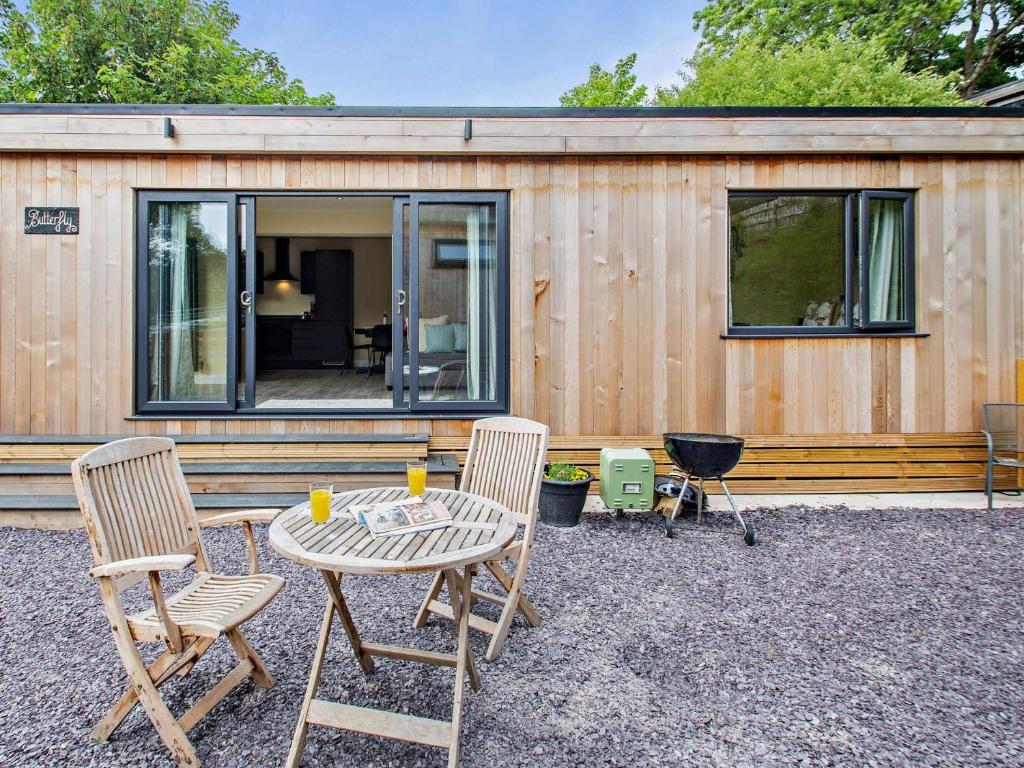 a small house with a table and chairs in front of it at 1 Bed in Conwy 96068 in Llangelynin