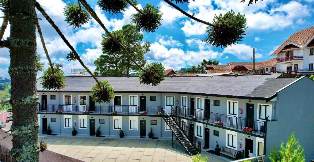 a building with a staircase in front of it at Villa Cristalle - Campos do Jordão in Campos do Jordão