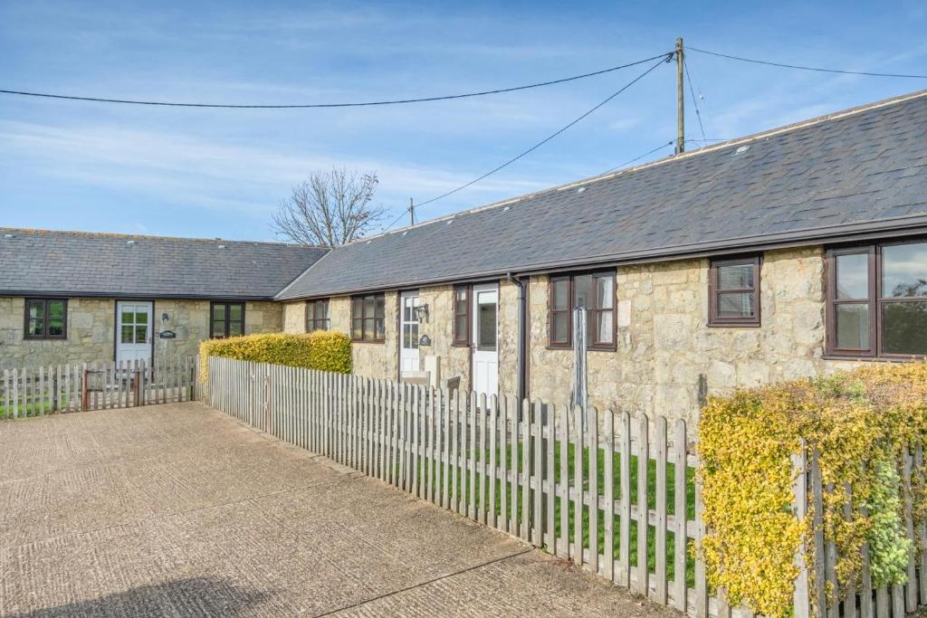 a brick house with a fence in front of it at 3 Bed in Whitwell oc-h33498 in Whitwell