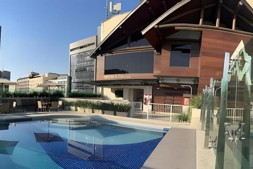a large swimming pool in front of a building at Studio Novíssimo Mauá 1108 in Rio de Janeiro