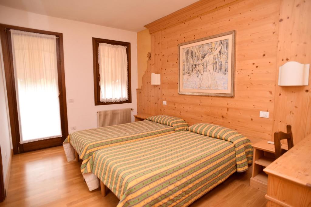 Postel nebo postele na pokoji v ubytování Albergo Da Gildo