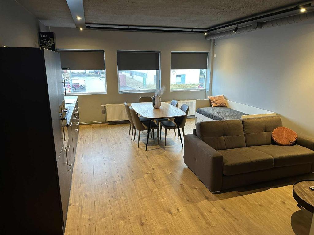 a living room with a couch and a table at Modern Apartment With Hot Tub in Akureyri in Akureyri