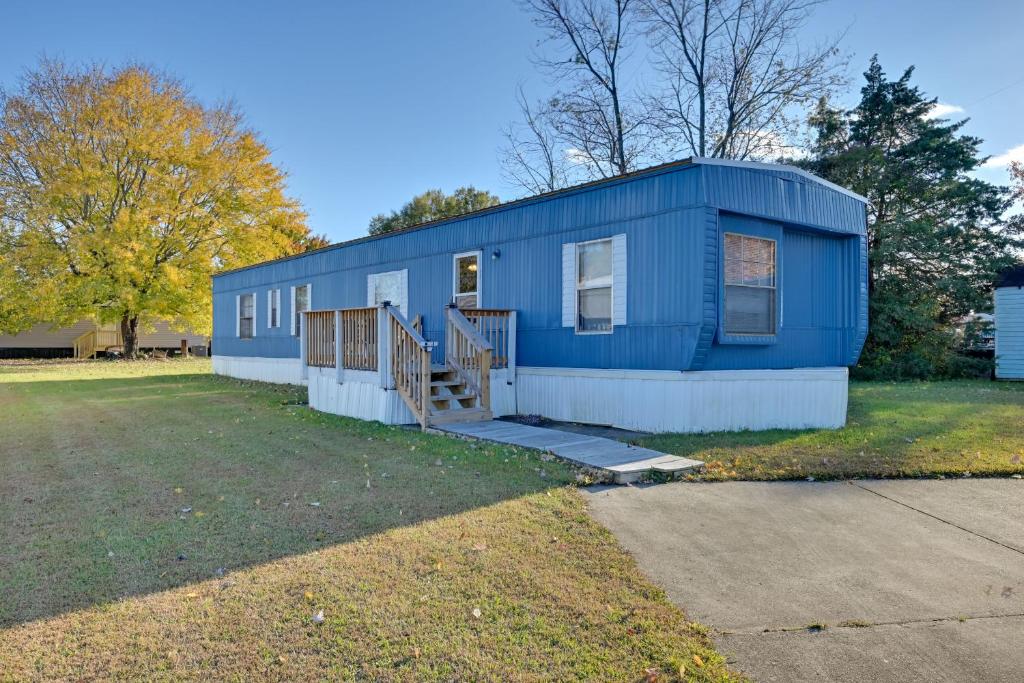 a blue house with a porch and a yard at Heart of Greensboro Pet-Friendly Gem 3 Mi to Dtwn in Fisher Park