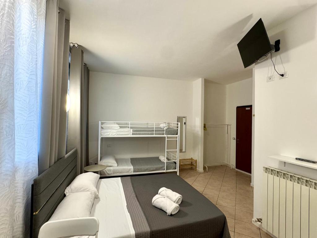 a bedroom with a bed with towels on it at Aparthotel Dergano 2 near metro stop in Milan