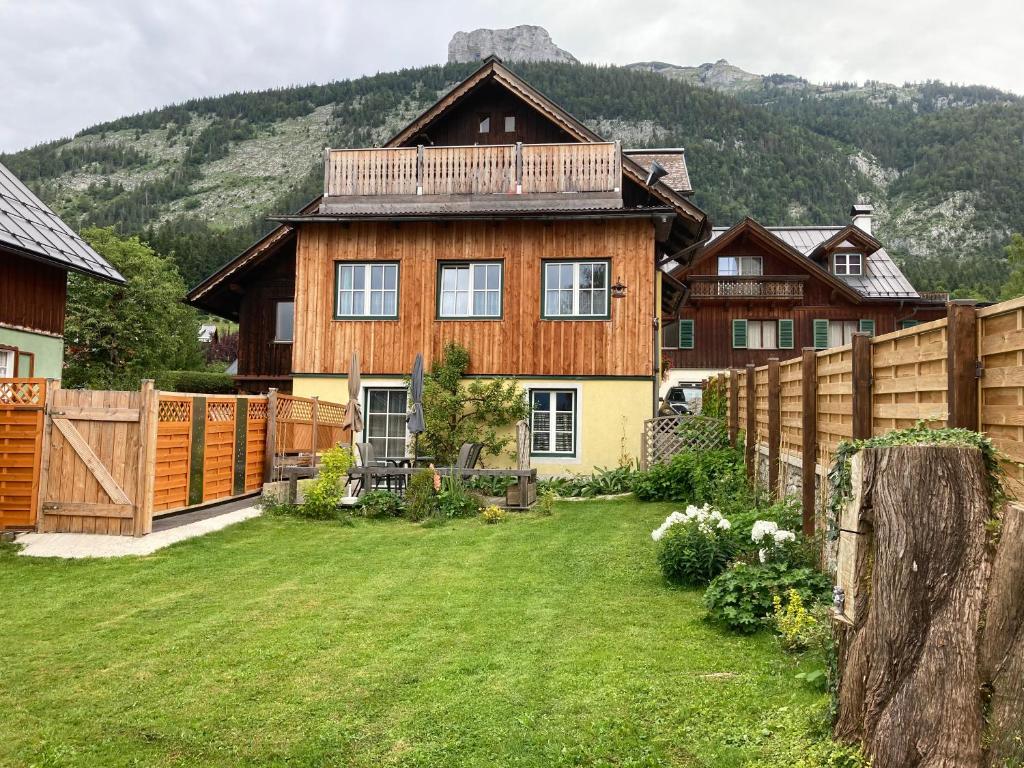 a wooden house with a fence and a yard at FW Langanger in Fischerndorf