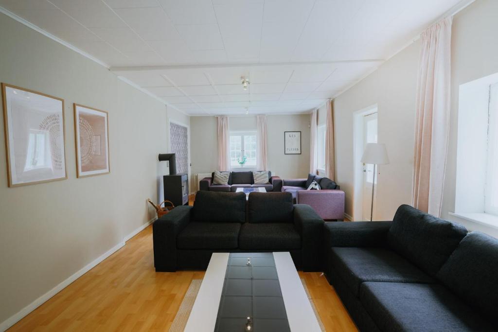 a living room with a couch and a table at The Farm Managers House at Hindemae Estate Historic Charmed house in Ullerslev