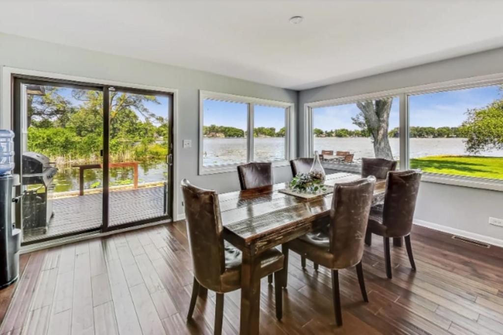a dining room with a wooden table and chairs at Month to Month and Seasonal Luxury Lakefront 5 bed 5 5 bath Estate Home in Ingleside