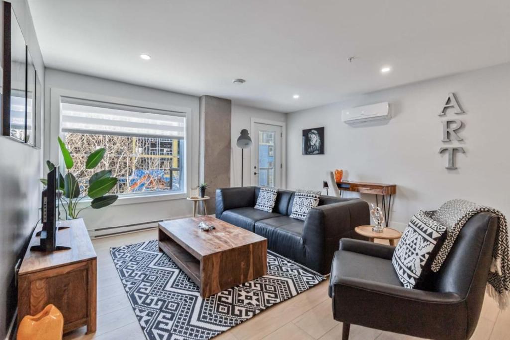 a living room with a couch and a table at Corporate Stays Millennium Boulevard 1 Bedroom in Moncton