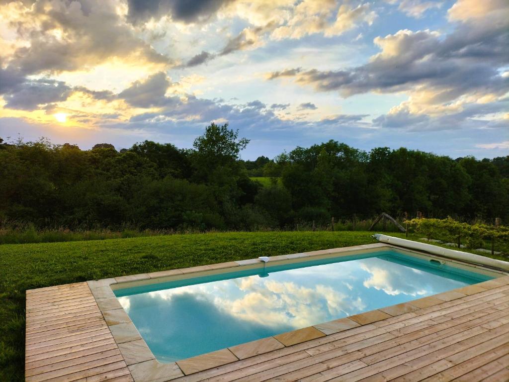 a swimming pool in the middle of a field at Maison basque de charme avec piscine in Souraïde