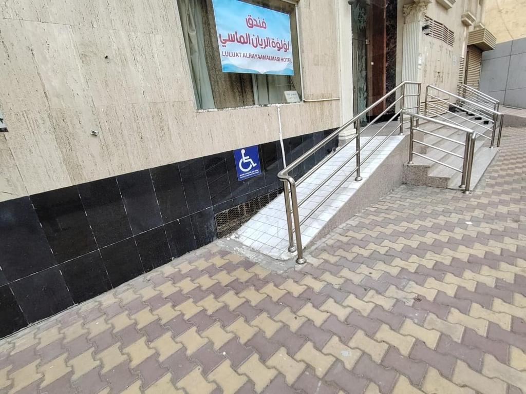 a staircase outside of a building with a sign on it at فندق لؤلؤة الريان الماسي in Quai