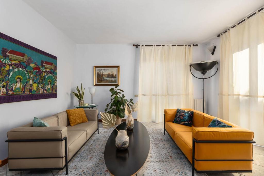 a living room with two couches and a table at Villa Luisa Design in Colle Val D'Elsa