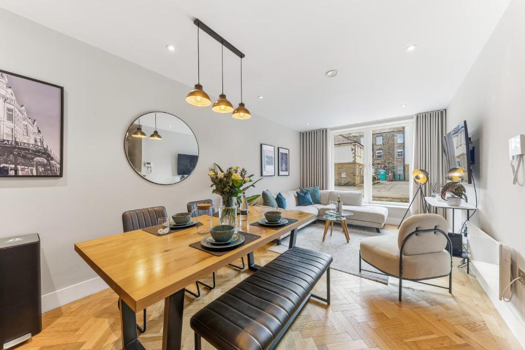 a dining room and living room with a table and chairs at Lambert House Two in Harrogate