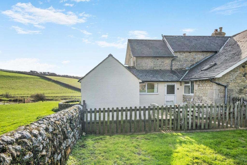 a stone house with a fence in front of it at 2 Bed in Whitwell oc-o33499 in Whitwell