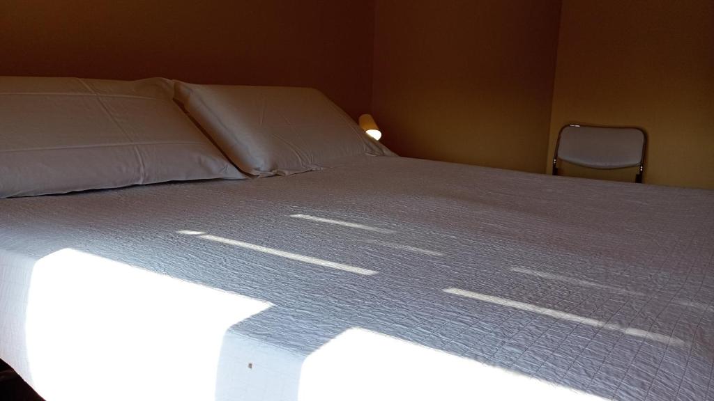 a bedroom with a bed with the sunlight shining on it at Home in Arezzo