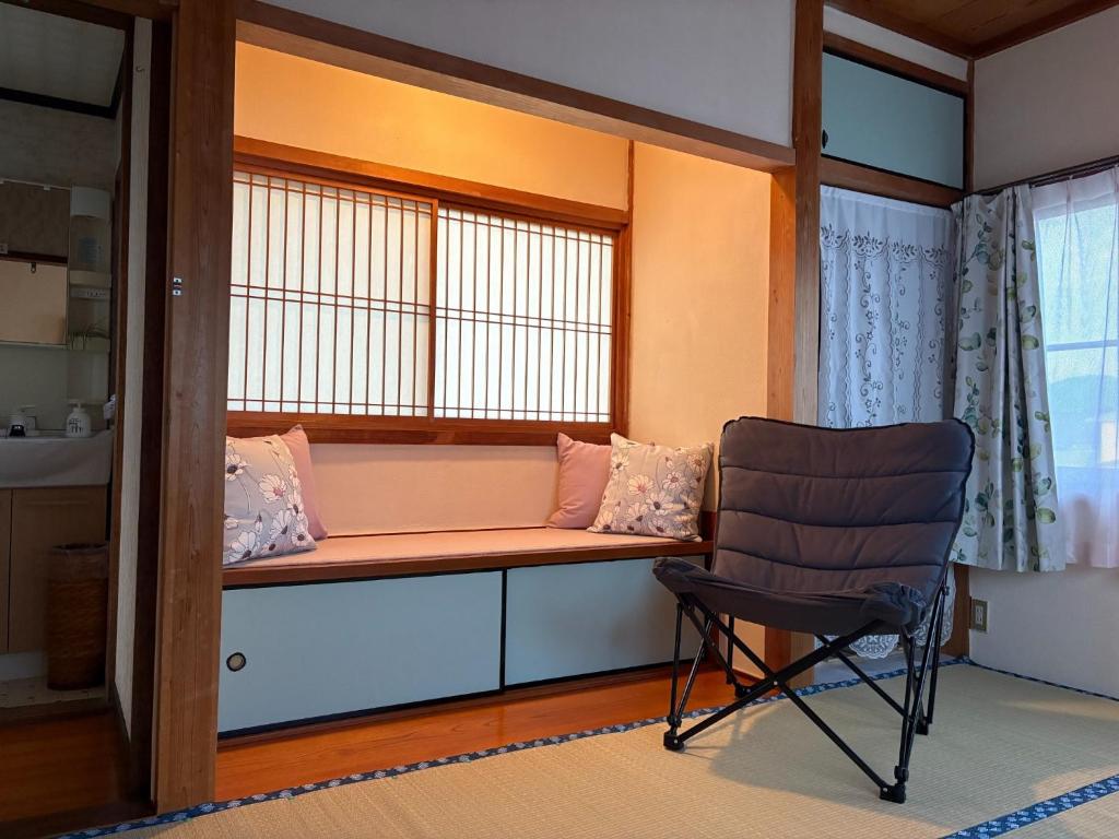 a chair sitting next to a window in a room at Kohaku - Vacation STAY 20481 in Nagahama