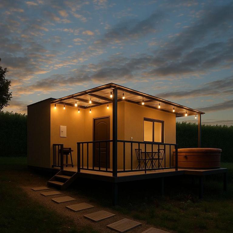 a house with lights on it with a surfboard at Wakana Ecosuits in Apulo