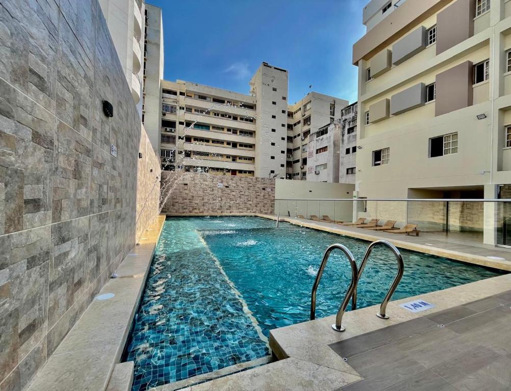 a swimming pool in the middle of a building at Hotel Chayrama in Santa Marta