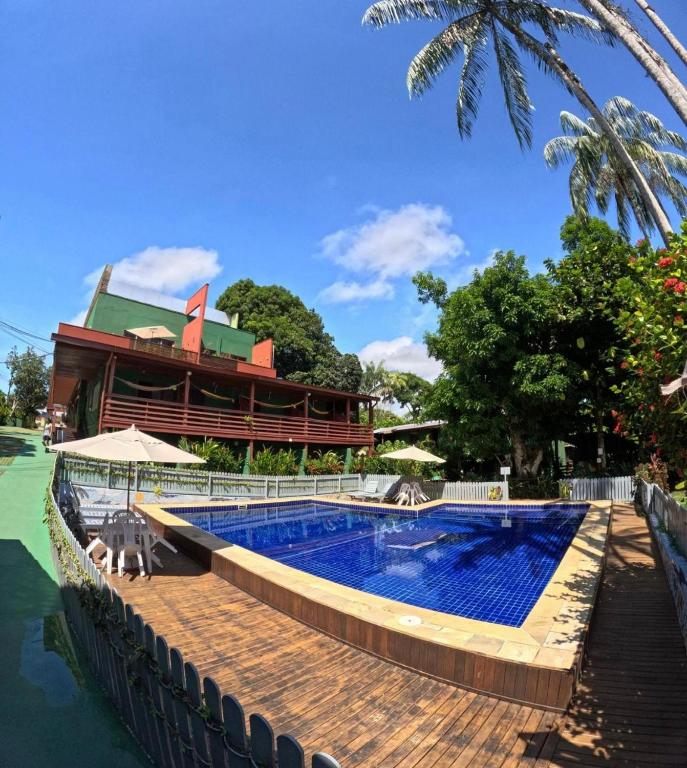 a pool at a resort with a building in the background at Bela Vista Lodge in Novo Airão