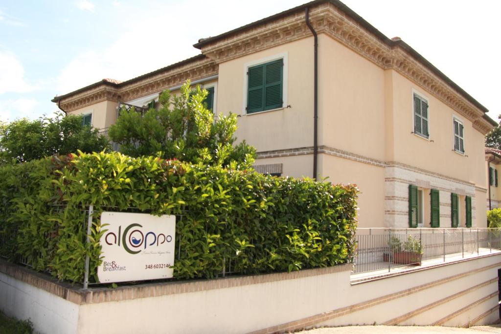 a building with a sign in front of it at Al Coppo in Sirolo