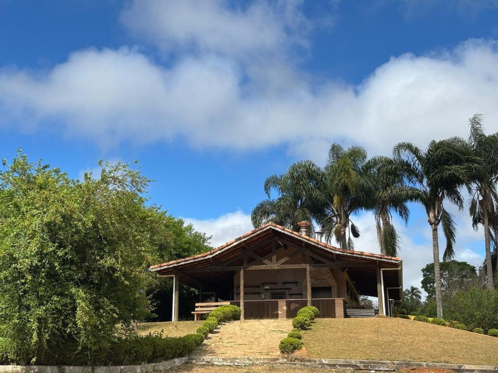 a house with palm trees in front of it at Fazenda do Sonhos - Cotia in Cotia