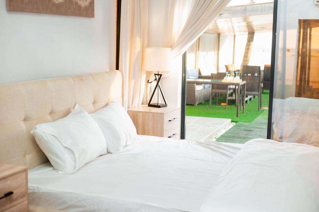 Voodi või voodid majutusasutuse Seagrass beach house toas