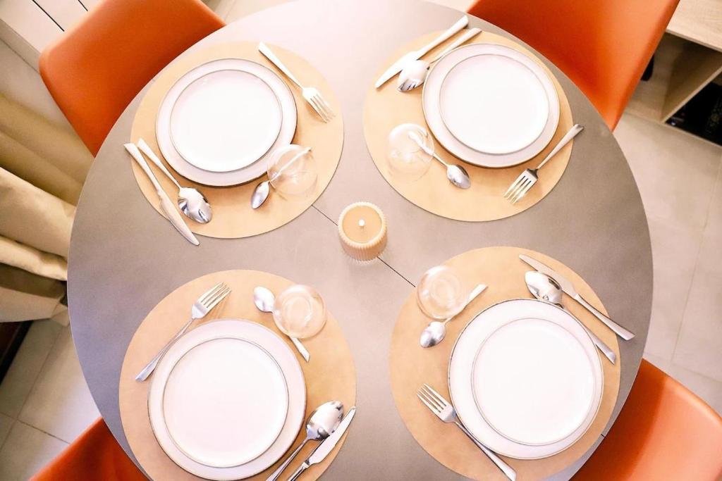 a table with white plates and silverware on it at anthony meggy in Thiron-Gardais